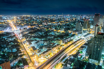 Naklejka na ściany i meble Bangkok at Night, City scape view on metropolis of Thailand and Cloudy blue sky