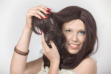 Woman with red nails demonstrated a  wig