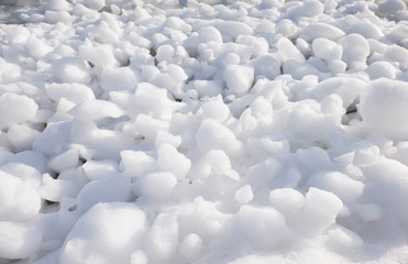 Lumps of snow and ice frazil on the surface of the freezing rive