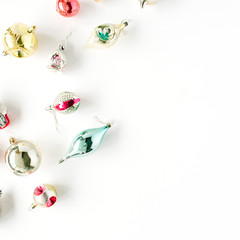 creative arrangement of bright christmas balls and toys on white background. flat lay, top view