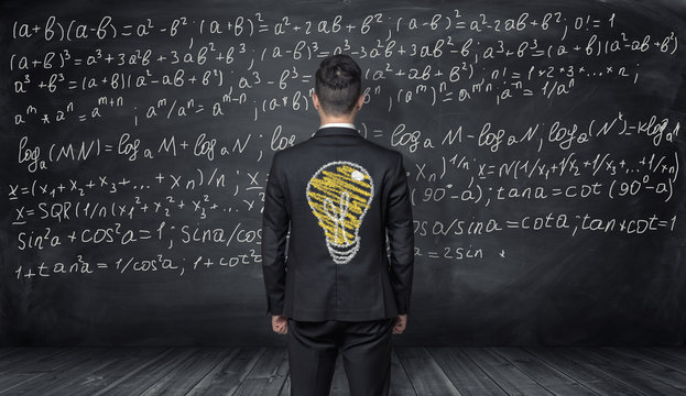 Businessman standing with the drawing of light bulb on his back