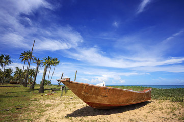 Beautiful tropical beach with coconut palm tree, fisherman boat