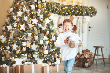 happy child girl with Christmas present morning