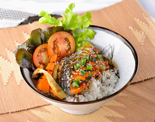 Grilled fish with rice, soy sauce.