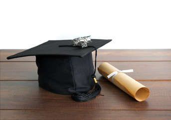 graduation cap, hat with degree paper and plane toy on wood tabl