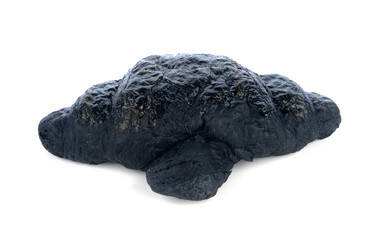 Charcoal croissant on white background