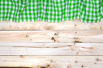 Green tablecloth on wooden table, top view