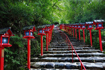 Fototapeta na wymiar Red light poles continued staircase entrance to Kibune-jinja shr