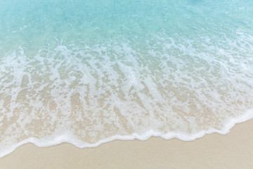Close up blue sea water waves on white sand beach,Beautiful blue ocean beach close up shot, Clean beach with blue sea in Thailand