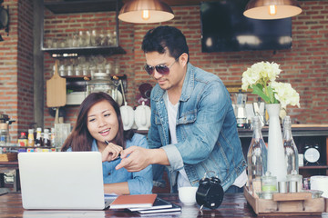 Two young business working on their laptop, While sitting in a c