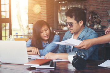 Two young business working on their laptop, While sitting in a c