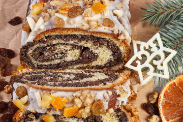 Homemade poppy seeds cake and spruce branches, dessert for Christmas
