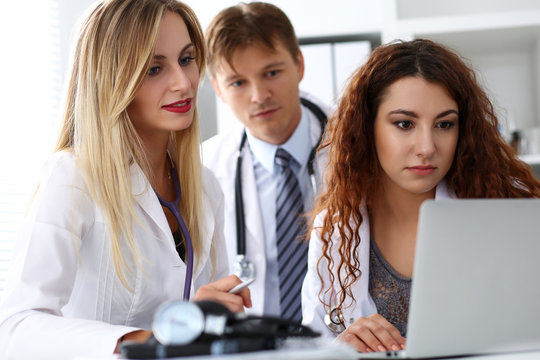 Group of doctors using laptop pc sitting in office