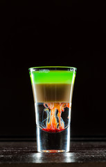 Colorful alcoholic cocktail in a shot glass