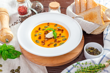 Pumpkin soup in white plate