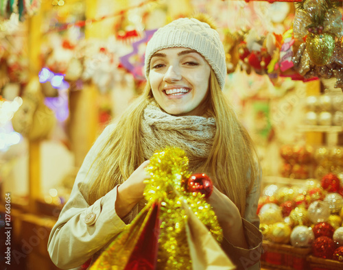 &quot;woman shopping at Christmas fair before Xmas in evening time&quot; photo