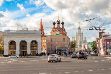Fototapeta na wymiar Taganskaya square, building the subway, the Church of St. Nicholas and stalinist skyscraper, the bustling traffic, Moscow urban cityscape