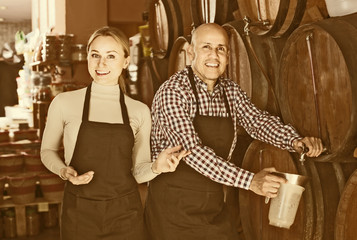 Portrait of two adult glad wine makers