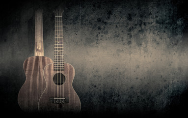 Fototapeta na wymiar Part of a orange acoustic guitar on black background.
