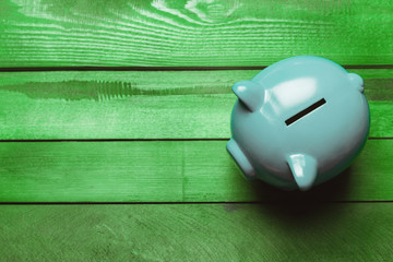 piggy bank on a green wooden table