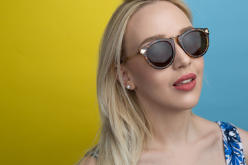 Fototapeta premium Young woman smiling with beautiful blond hair over color backgro