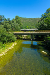 Fototapeta na wymiar Small railway bridge over a river