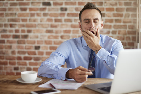 Yawing man behind the desk