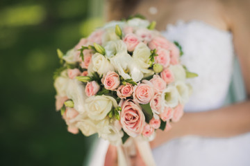 closeup photo of bride holding a flower bouquet