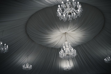 vintage beautiful crystal chandeliers on the ceiling