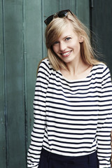 Blond and beautiful woman in striped top, portrait