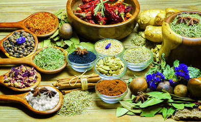 Spices and herbs placed on wooden background.Food and cuisine ingredients. Colorful additives.