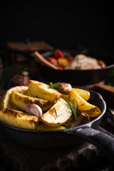 Delicious Christmas themed dinner table with baked potatoes and garlic. Holiday concept with copy space.