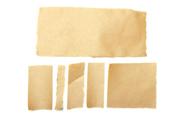 brown ripped pieces of paper on white background