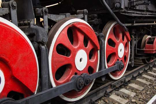 big red wheels of old steam engine