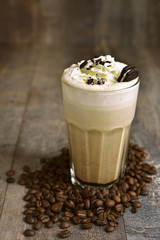 Italian latte with whipped cream and cookies.