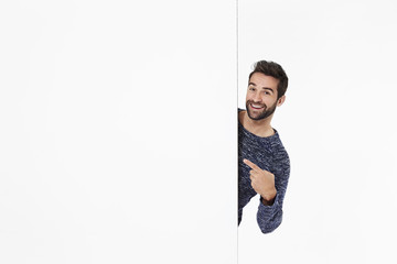 Man pointing to blank space, portrait