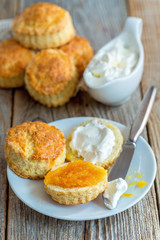 Scones with orange jam and whipped cream for breakfast.