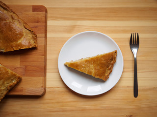 Homemade baked meat pie on white plate