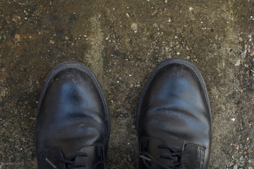 black shoes standing on the concrete floor