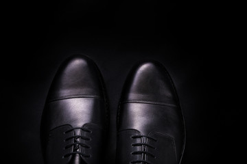 Black oxford shoes on  background. Top view. Copy space.