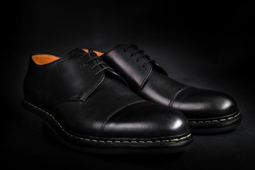 Black oxford shoes on  background. Back view. Close up.