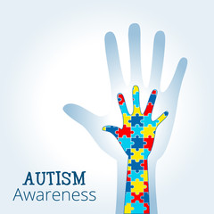 Autism awareness concept with hand of puzzle pieces as symbol of autism.