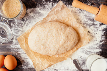 Baking background. Baking ingredients with dough on the wooden table