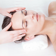 Woman during nice face massage in spa