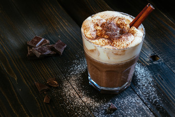 hot chocolate with whipped cream on the black table