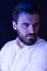 Obraz premium Portrait of a bearded man light by fluorescent light. Bearded m