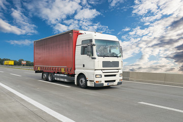 Fototapeta na wymiar Transport von Waren - LKW auf der Autobahn // shipping- truck on highway