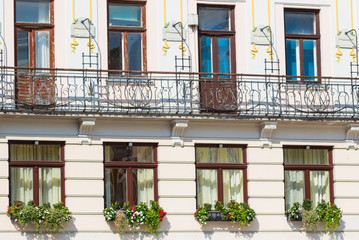 Fototapeta na wymiar detail of windows and balcony with beautiful flower , Pattern of windows and balconies in modern building.