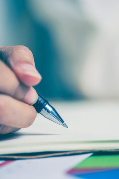 Business women hands working writing notebook on wooden desk, lighing effect