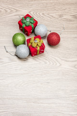 Christmas decorations are on the wooden table.